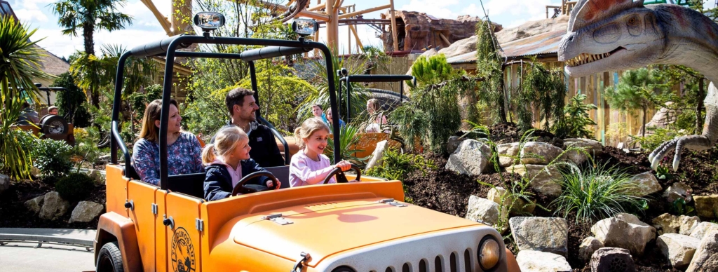 Family enjoying the dinosaur company jeep ride in Lost Kingdom at Paultons Park. 