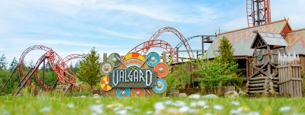 Valgard Realm of the Vikings themed area with entrance sign, coaster track and Viking buildings at Paultons Park