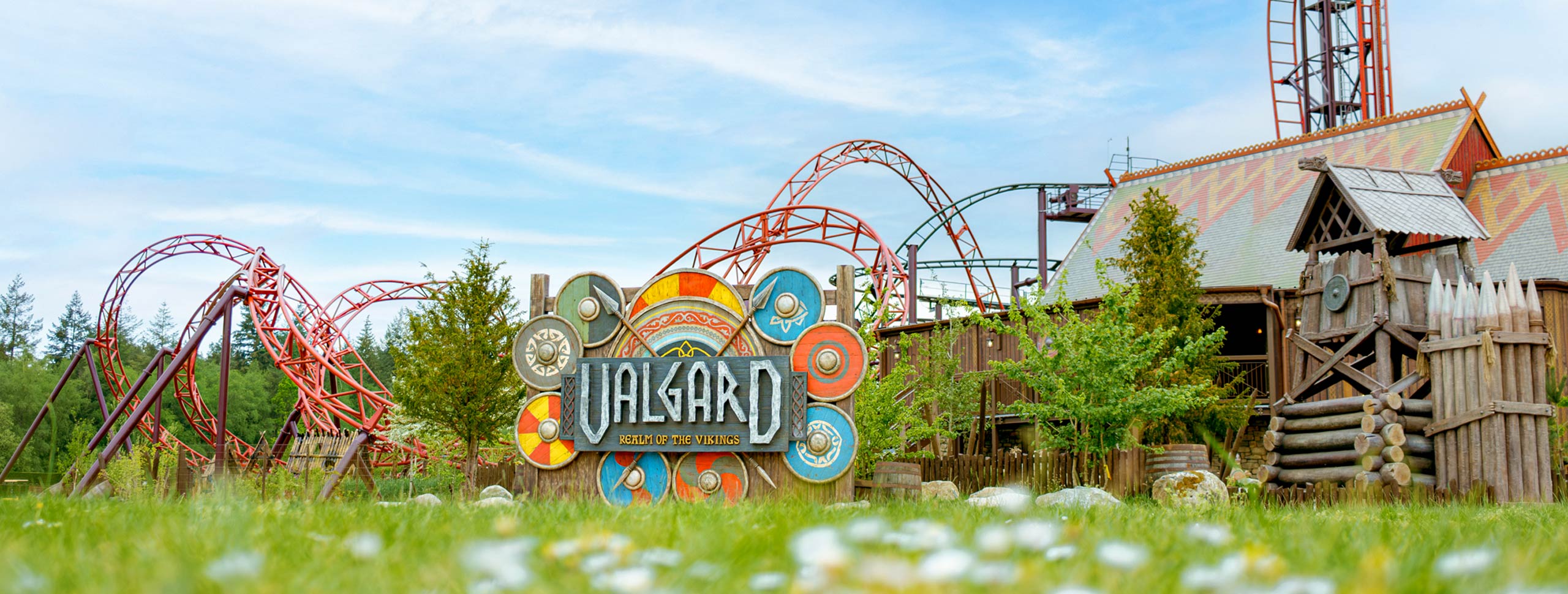 Valgard Realm of the Vikings themed area with entrance sign, coaster track and Viking buildings at Paultons Park